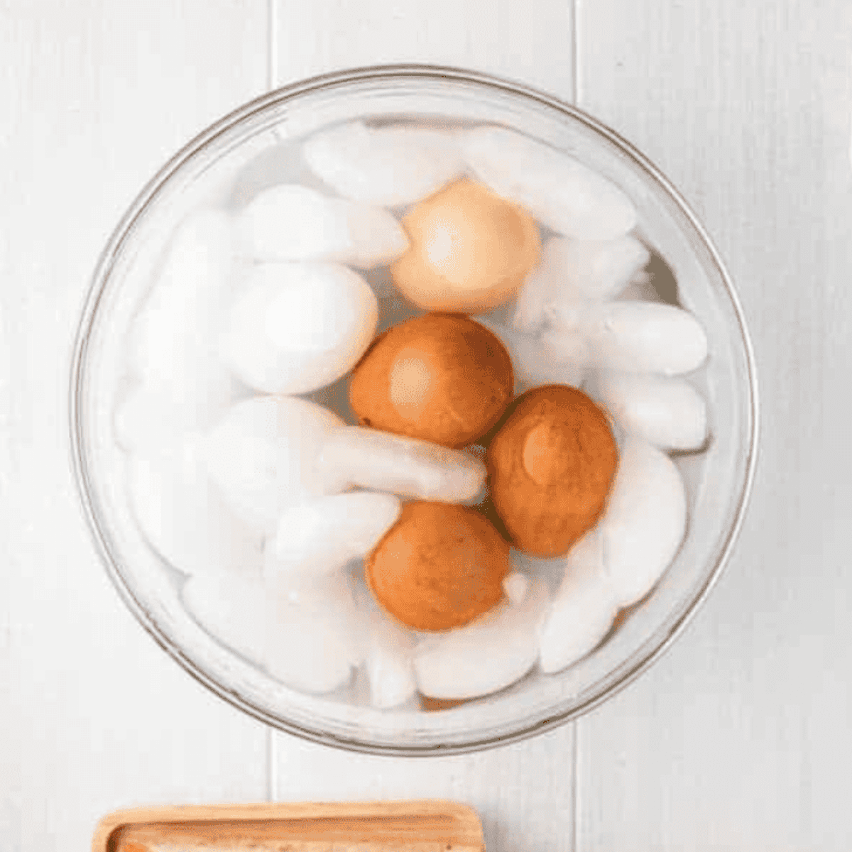 Place cooked eggs into an egg bath.