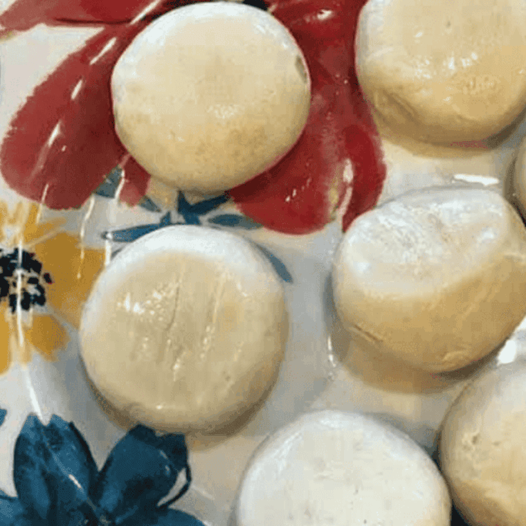 Ingredients needed for Air Fryer Garlic Parmesan Monkey Bread on kitchen table.