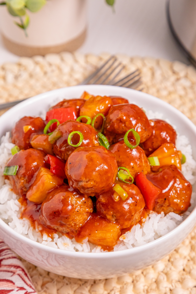 Air Fryer Honey Garlic Meatballs in a shallow bowl, coated in a thick glossy honey garlic glaze