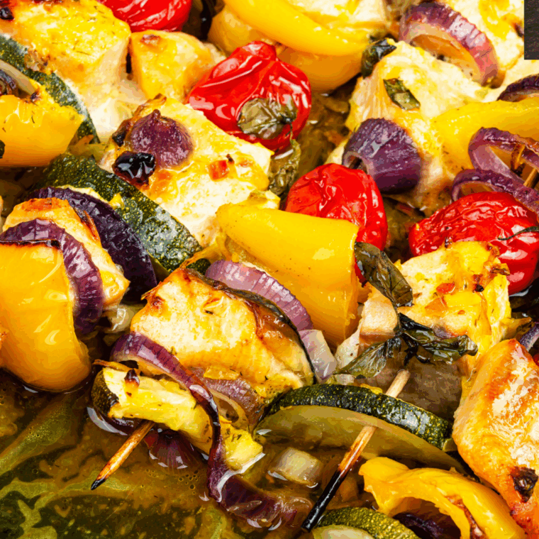 Air Fryer Salmon Kebabs plated with fresh lemon slices and garnished with herbs.