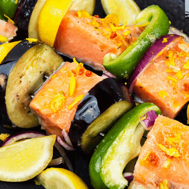 Uncooked Salmon Kebabs in the air fryer basket.