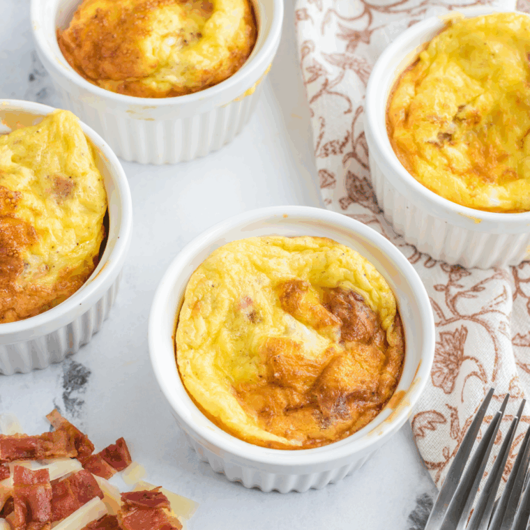 A mug of fluffy scrambled eggs made in the air fryer, ready to enjoy for a quick breakfast.