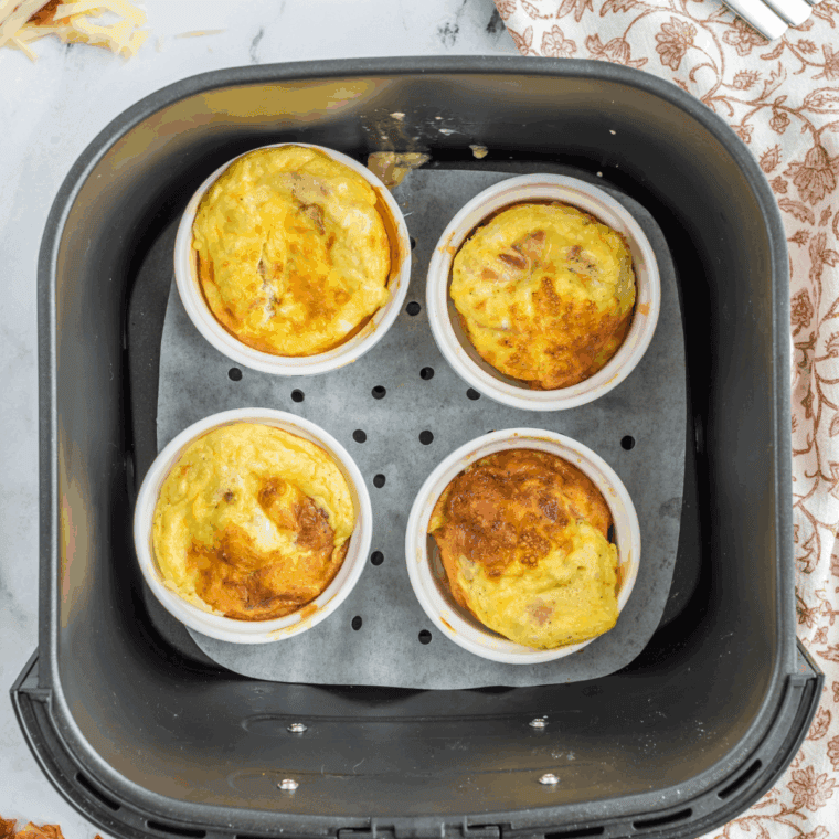 A mug of fluffy scrambled eggs made in the air fryer, ready to enjoy for a quick breakfast.