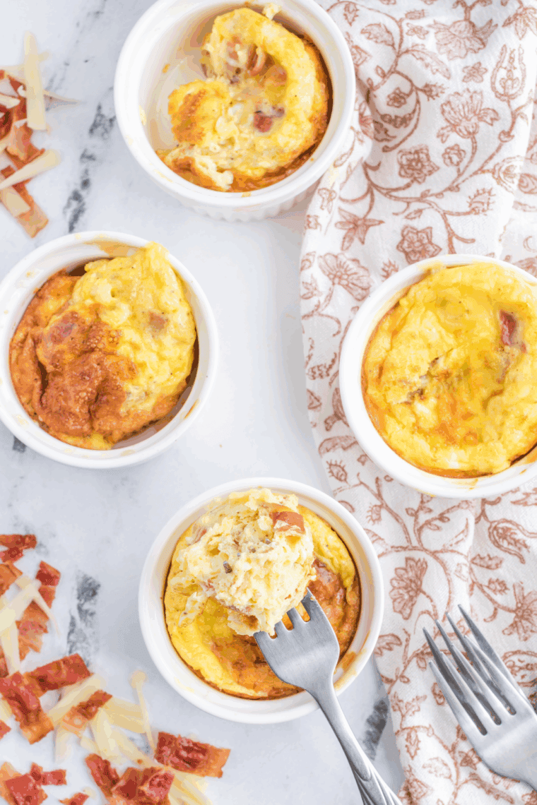 A mug of fluffy scrambled eggs cooked in the air fryer, perfect for a quick and easy breakfast.