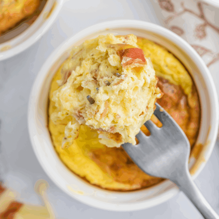 A mug of fluffy scrambled eggs made in the air fryer, ready to enjoy for a quick breakfast.