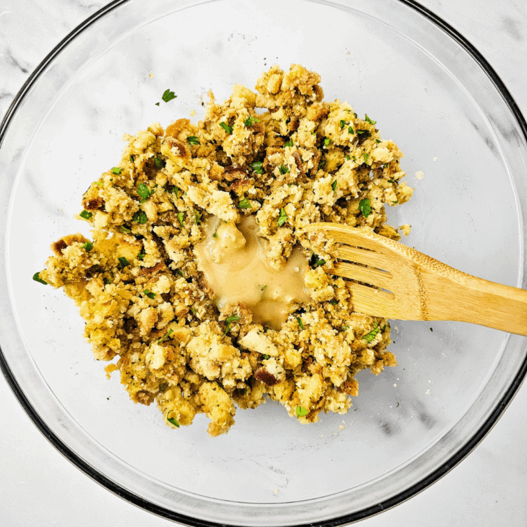 Stuffing mixture scooped into muffin cavities using an ice cream scoop.