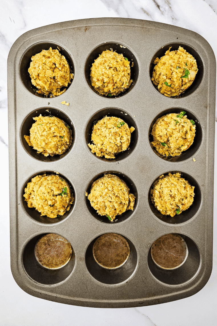 Muffin pan cooking in air fryer until tops are golden and crispy.