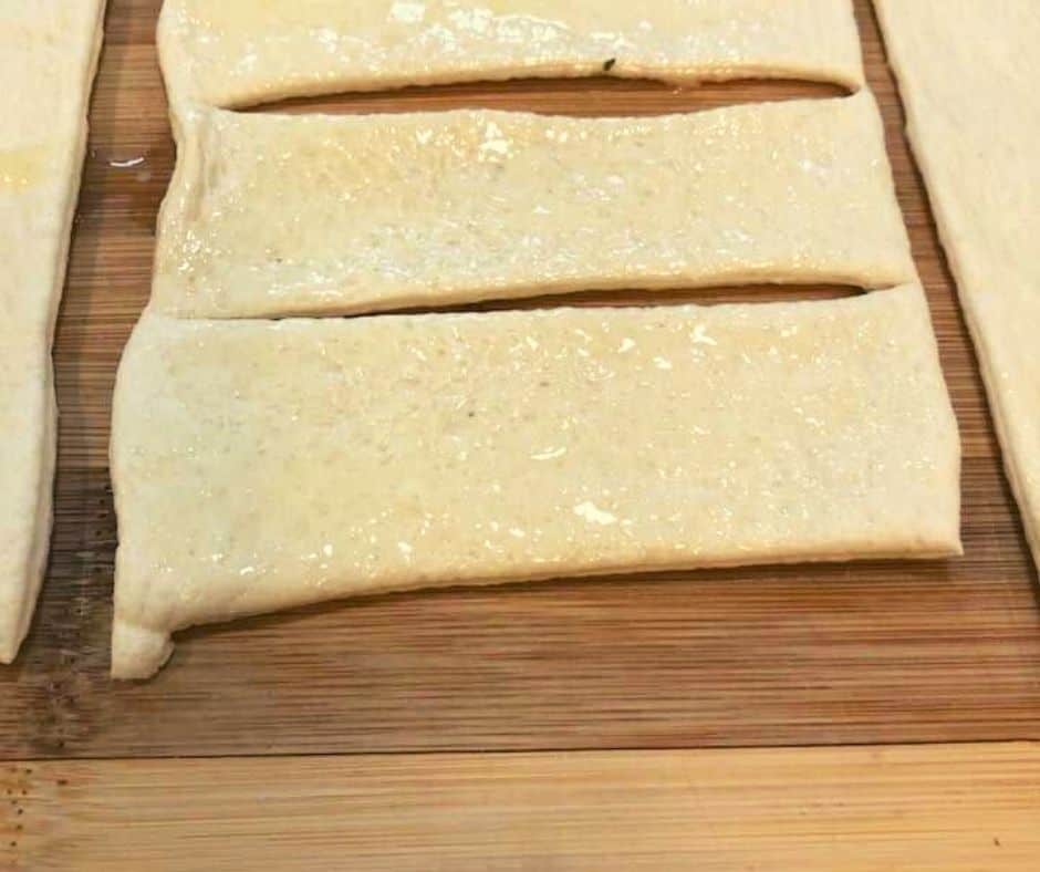 Cut the dough into long strips, and then cut the strips in half. Note: The size of the breadsticks is going to be determined by how large your basket is. 