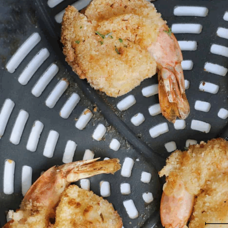 Golden, crispy Arthur Treacher’s fried shrimp arranged on a plate with tartar sauce.