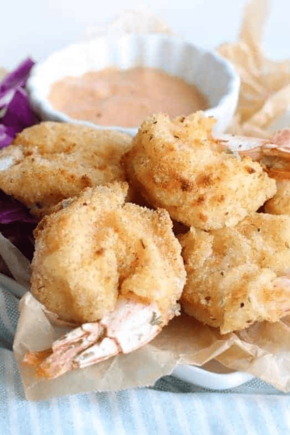 Golden, crispy Arthur Treacher’s fried shrimp served on a plate with tartar sauce.