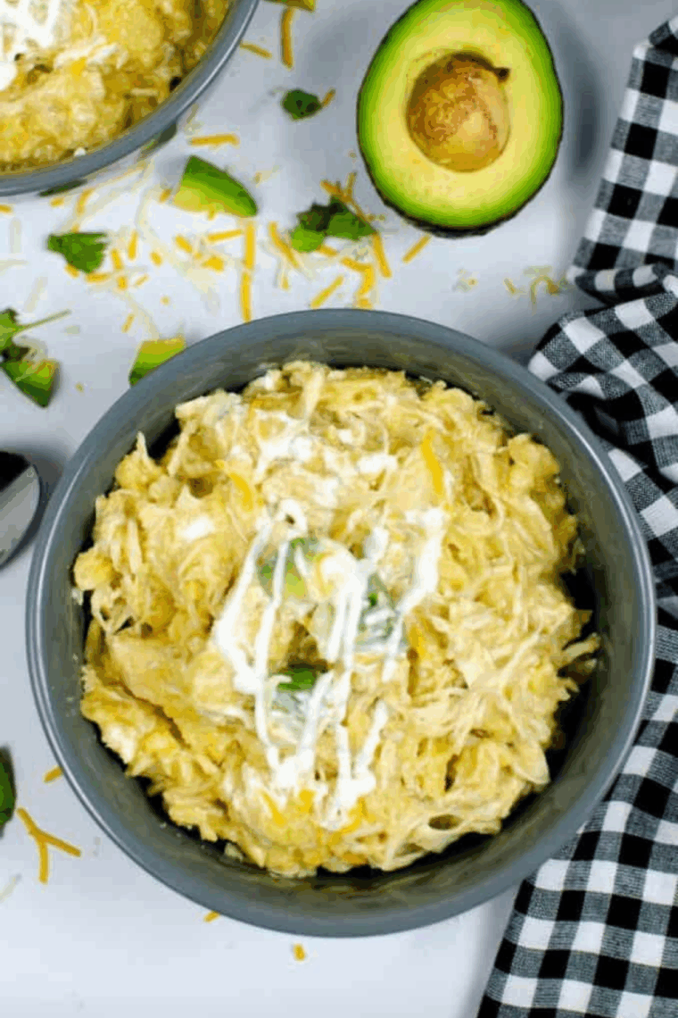 Plate of Copycat Chili’s Green Chili Chicken Enchiladas with toppings.