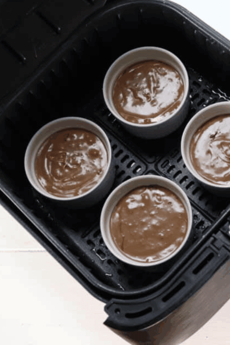 Add filled ramekins to the air fryer basket.