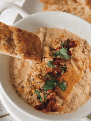 "Crispy baked pita chips seasoned with olive oil and spices served as a crunchy Mediterranean snack for dipping"