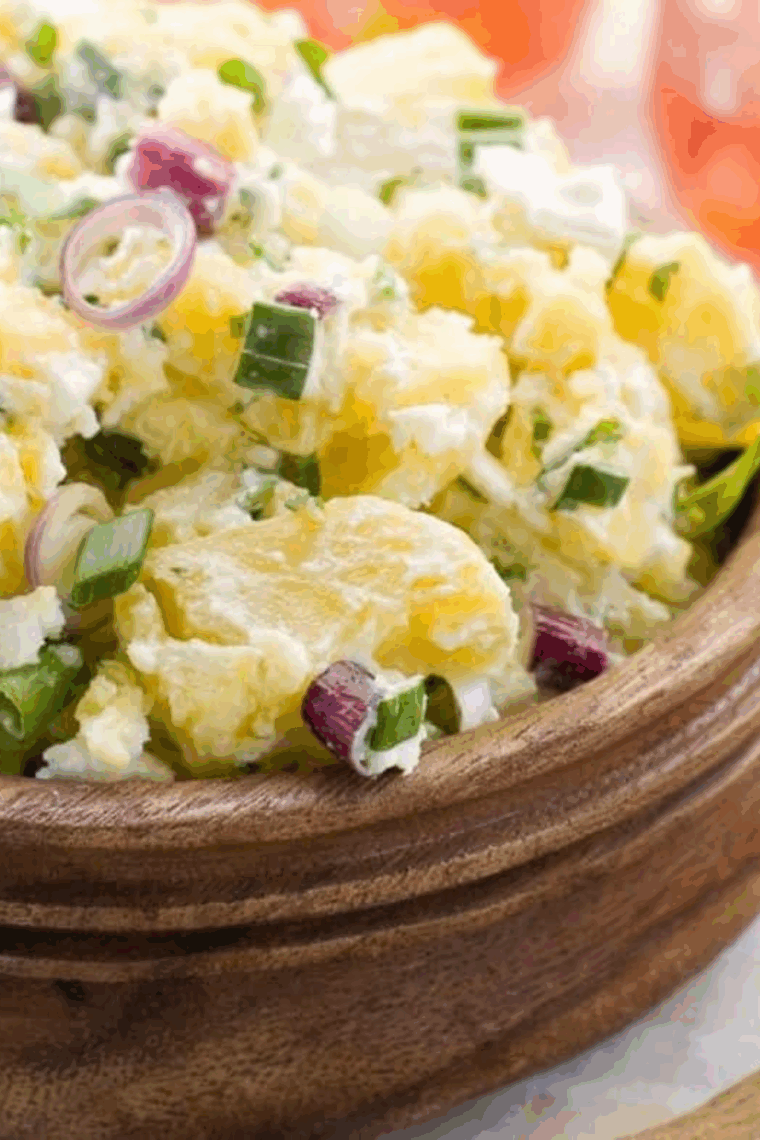 Bowl of creamy Hellmann&rsquo;s Original Potato Salad with chopped potatoes, eggs, onions, and classic seasonings.