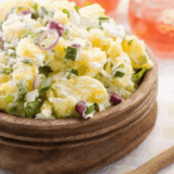 Bowl of creamy Hellmann&rsquo;s Original Potato Salad with tender potato chunks and classic seasonings.