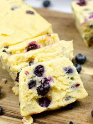 Sliced Instant Pot Blueberry Loaf showing moist crumb and fresh blueberries inside