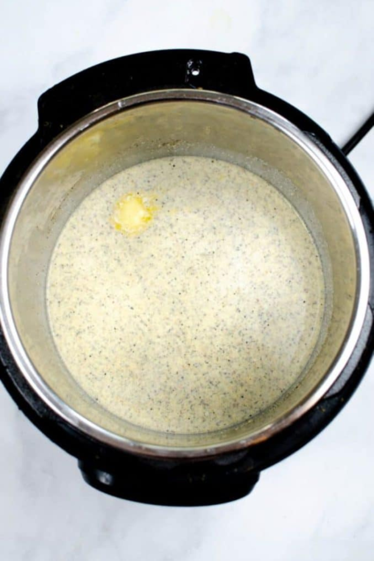 Instant Pot on sauté mode with butter, half-and-half, lemon zest, and seasonings being stirred to create a creamy sauce before mixing in pasta.