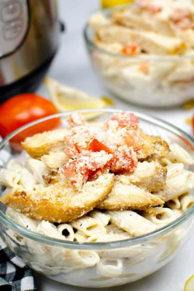 A plate of Instant Pot Chili's Copycat Cajun Chicken Pasta featuring creamy penne pasta, Cajun-seasoned chicken strips, and a sprinkle of fresh parsley.