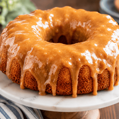 Air fryer cinnamon swirl bundt coffee cake with caramel glaze dripping down the ridges