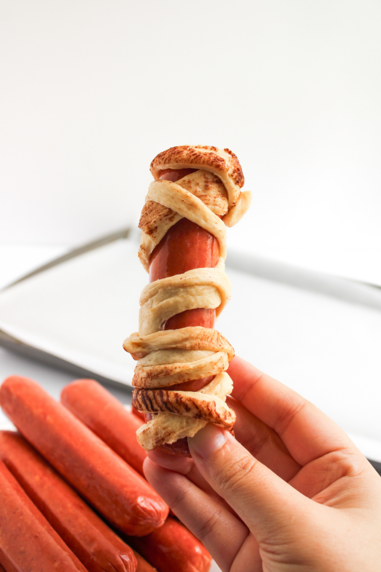 Wrapped mummy hot dogs brushed with egg wash for golden finish.