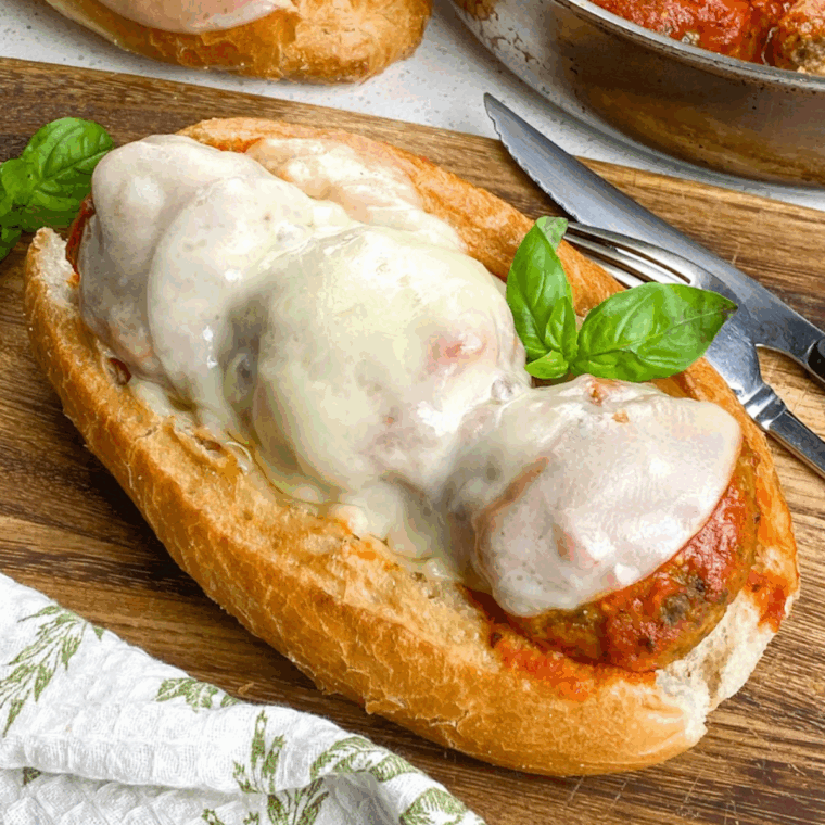 Golden Bobby Flay meatballs served with marinara sauce and parsley