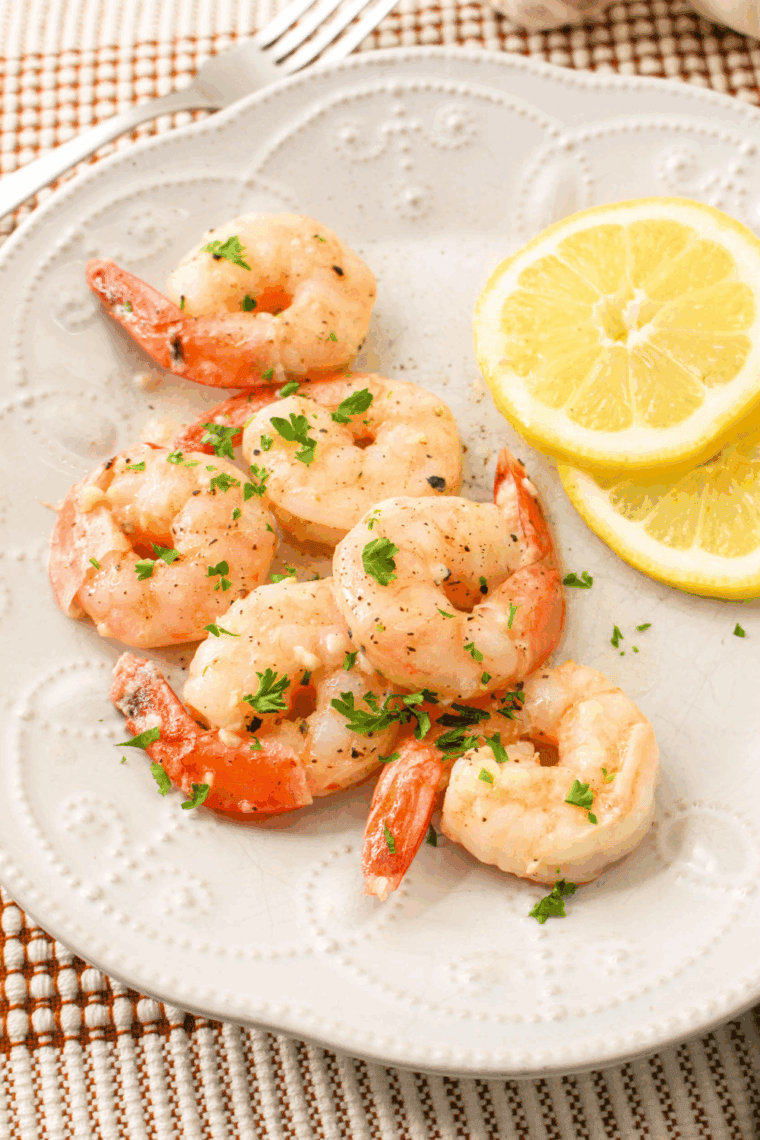 Sautéed shrimp in garlic butter sauce with lemon and parsley over pasta, inspired by Carrabba's Shrimp Scampi recipe