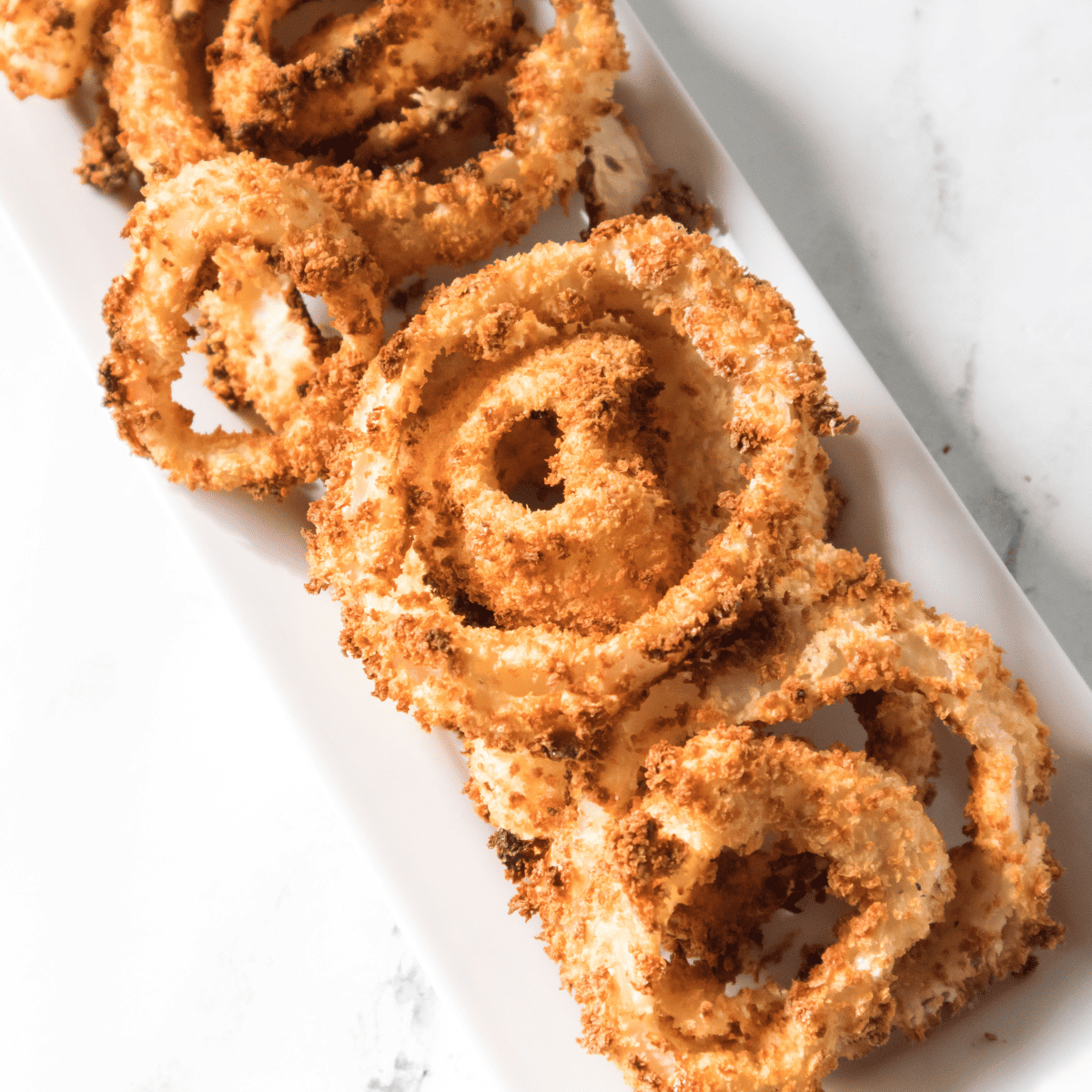 Golden crispy homemade A&W copycat onion rings on a plate