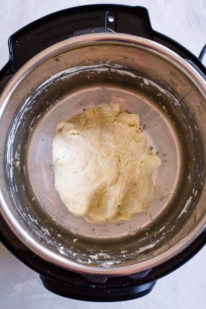 Make a ball out of the dough and leave it in the Instant Pot. Cover with the glass lid of the pot or with a plate: you don't need to use the pressure lid.