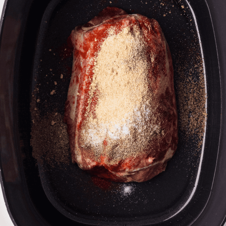 Pork shoulder chunks coated in a brown sugar and smoked paprika dry rub for Instant Pot pulled pork.
