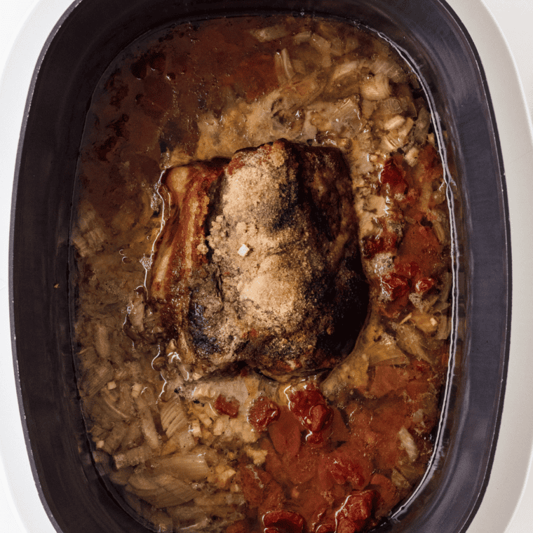 Seasoned pork shoulder browning in oil using the Instant Pot Saut&eacute; function.