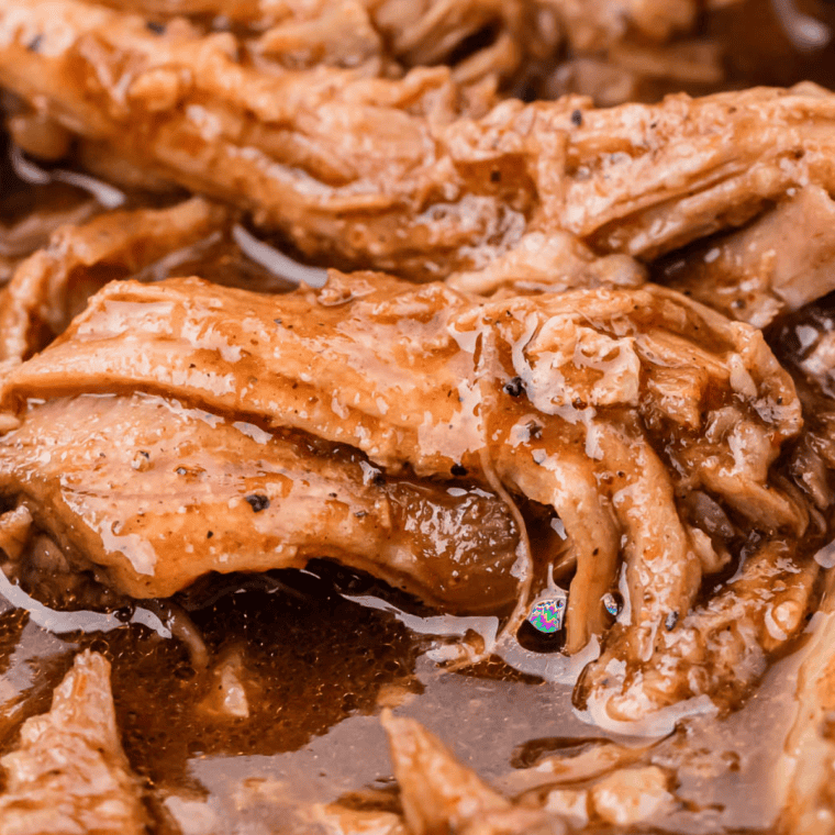 Instant Pot pulled pork sandwich made with a dry rub and BBQ sauce, piled high on a toasted bun.