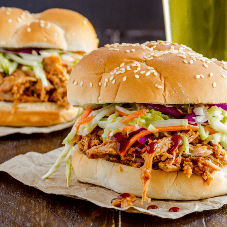 Instant Pot pulled pork piled onto a toasted bun and topped with coleslaw.