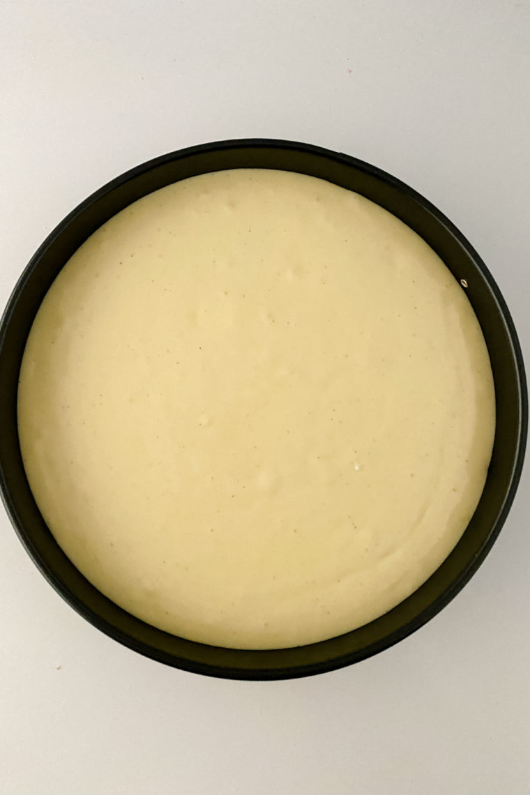 Cheesecake filling poured into prepared crust with air bubbles removed