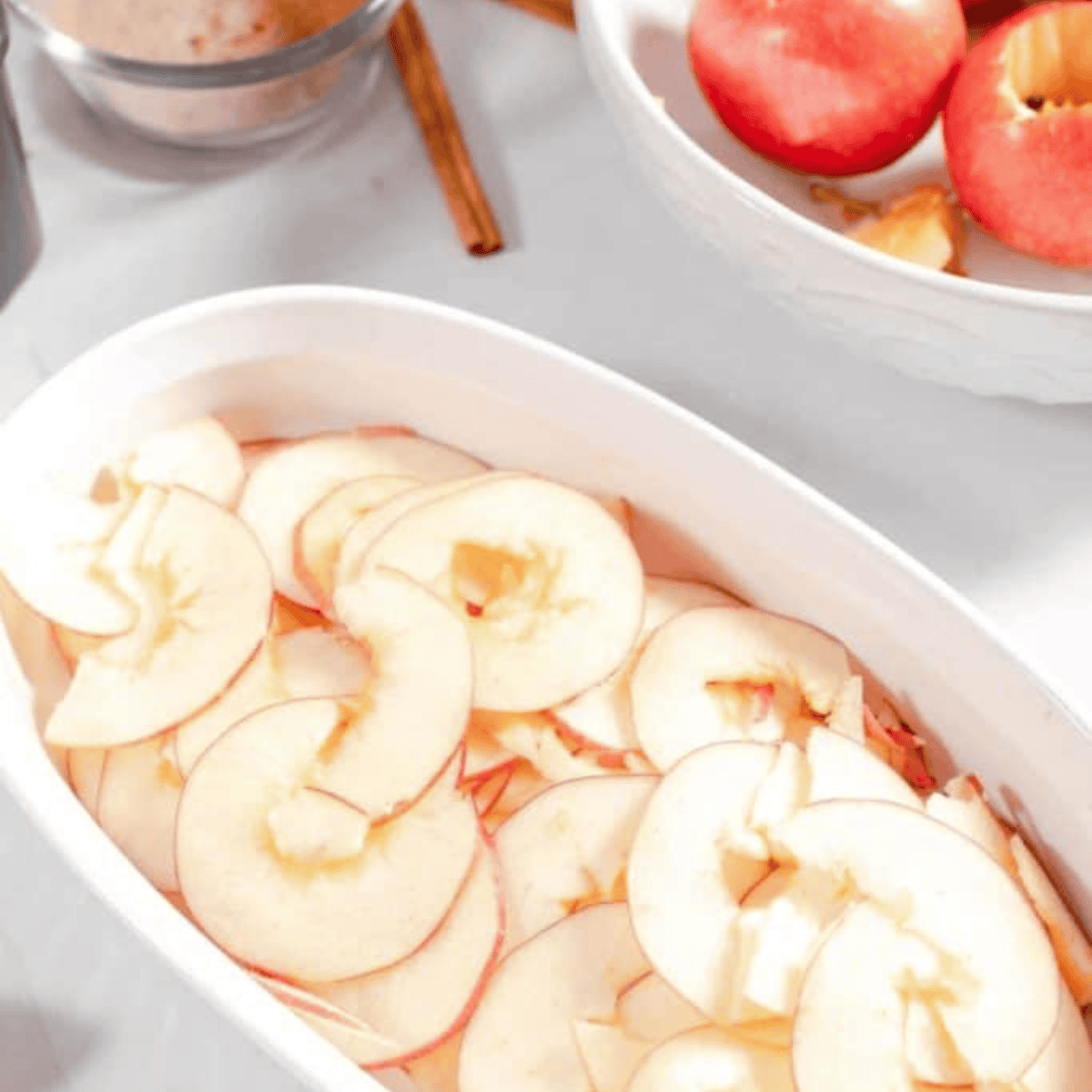 Thinly sliced apples being prepared for air fryer apple chips, ready to crisp.