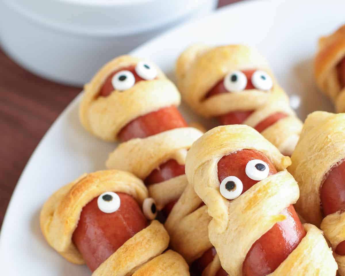 Quick & easy Air Fryer Mummy Pigs in a Blanket. 👻 All you need are: -  crescent roll dough - cheese - hot dogs - mustard & ketchup…