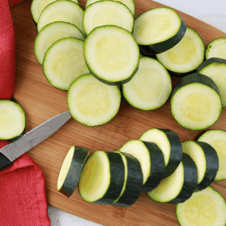 Ingredients needed for Air Fryer Cheddar Baked Zucchini on kitchen table.