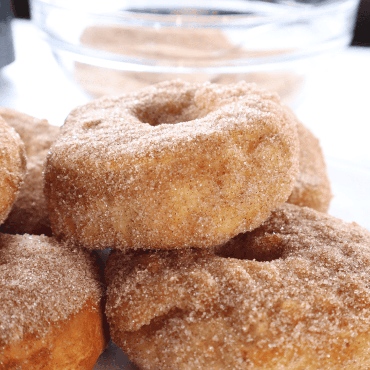 Air fryer cronuts made from refrigerated biscuits, coated in cinnamon sugar and crispy golden brown.