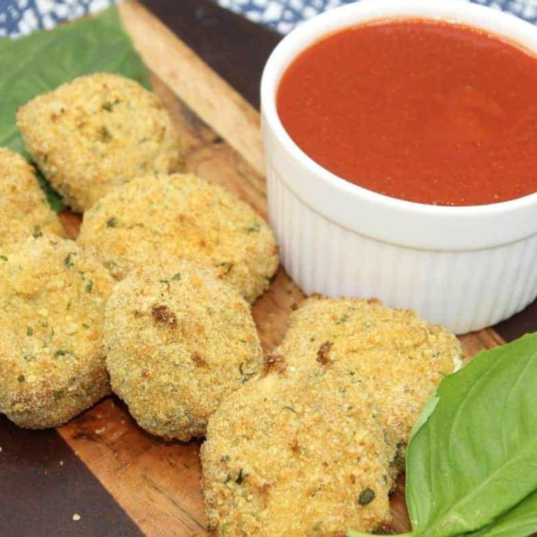 Plate of crispy fried goat cheese fritters on plate.