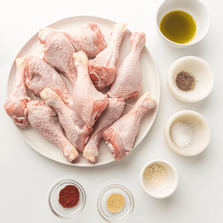 Ingredients needed for Air Fryer Frozen Chicken Drumsticks on kitchen table.