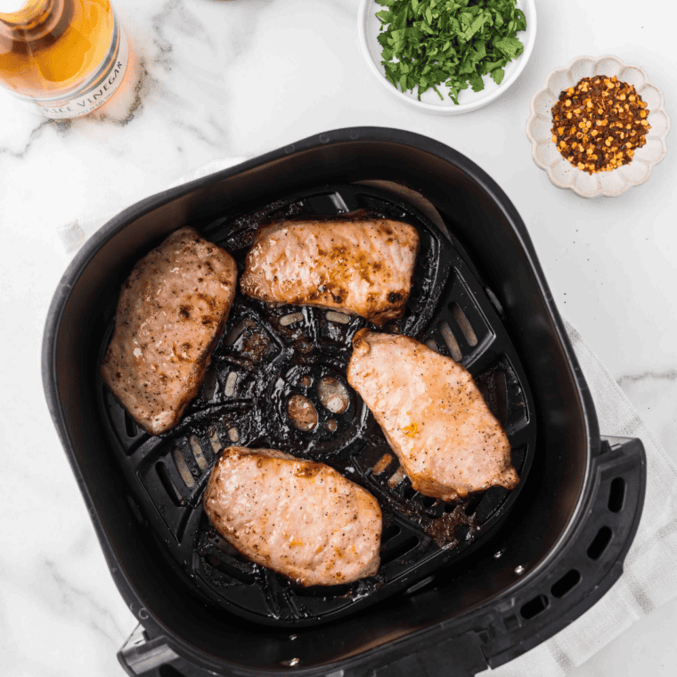 Frozen pork chops brushed with oil and coated in brown sugar spice dry rub