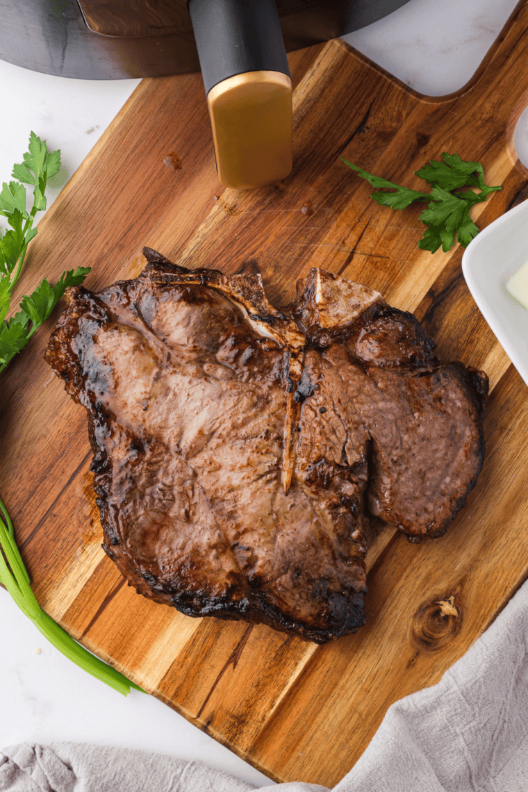 Thick porterhouse steak cooked in the air fryer with a golden crust and tender pink center.