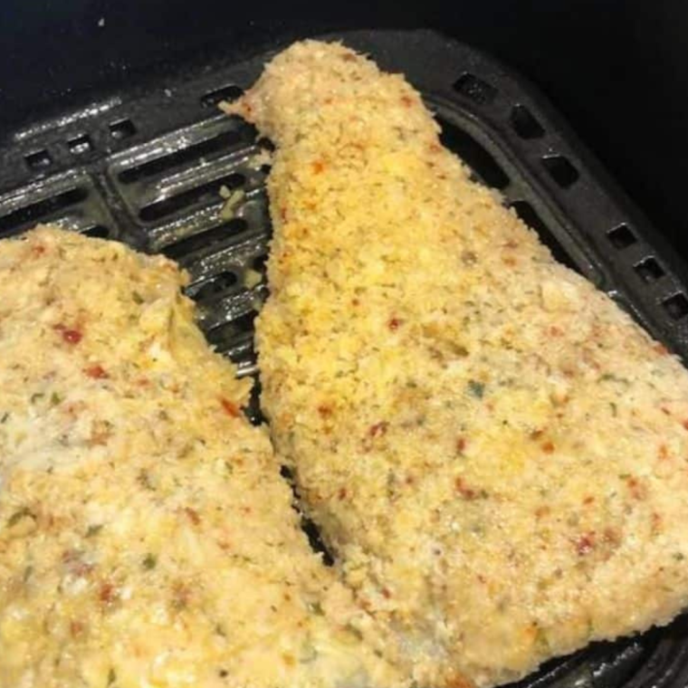 Parmesan Crusted Cod in the air fryer basket.