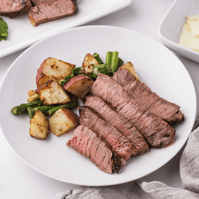 Air fryer porterhouse steak plated with mashed potatoes and asparagus