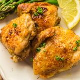 Air fryer turkey thighs on a platter garnished with fresh rosemary
