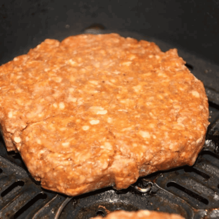 Arby’s Copycat BBQ Bacon Burger Recipe placed into the air fryer basket.