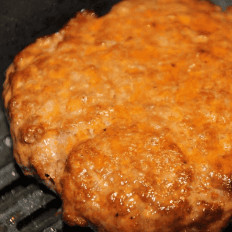 Cooked Arby’s Copycat BBQ Bacon Burger Recipe in the air fryer basket.