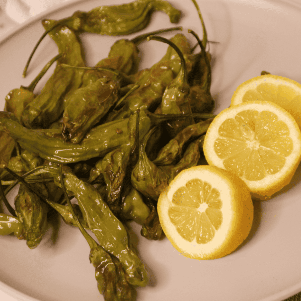 Blistered Benihana-style shishito peppers served hot with a sprinkle of salt.
