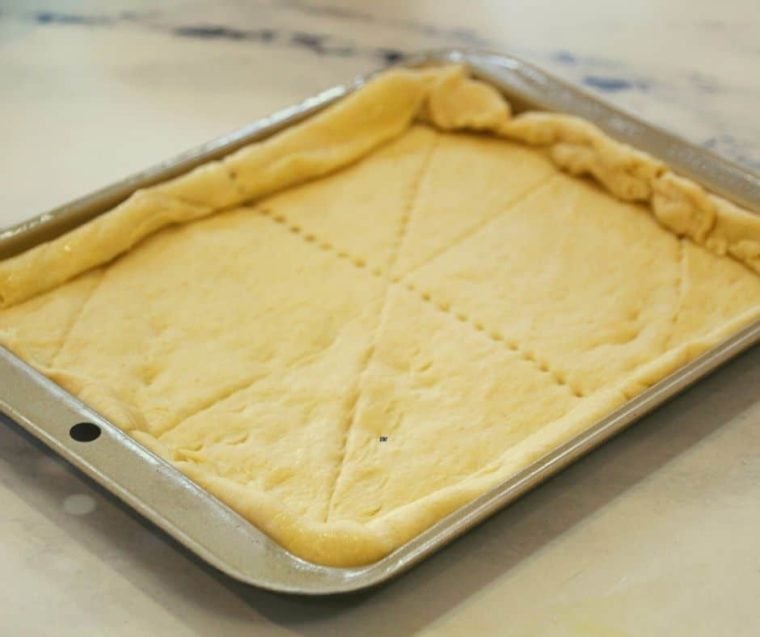 breakfast pizza with crescent rolls crust on air fryer rack ready to be cooked