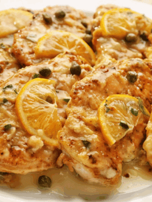 Homemade Carrabba’s Chicken Piccata with lemon-caper sauce served on a dinner plate.