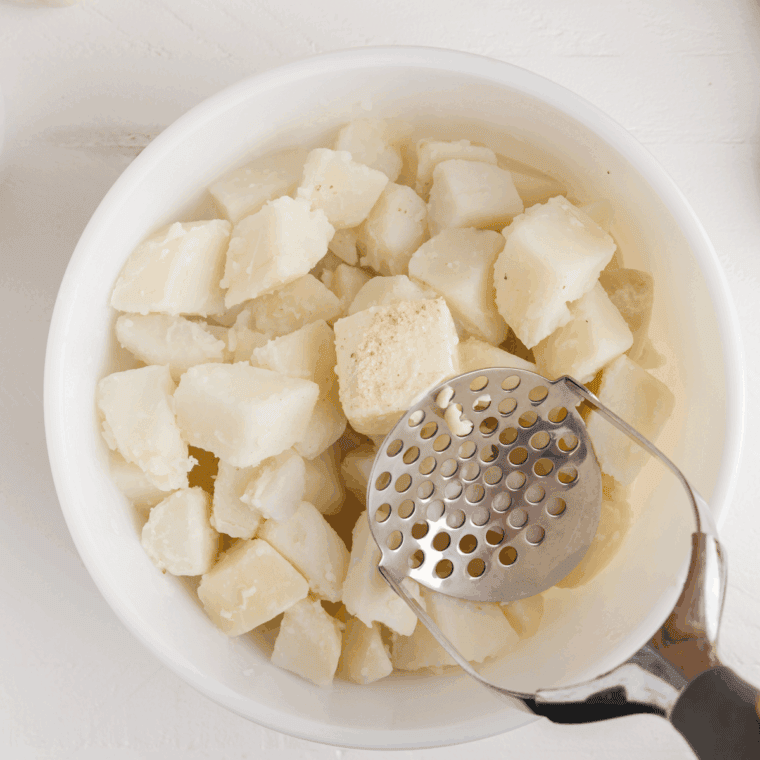 Mash the potatoes until smooth.